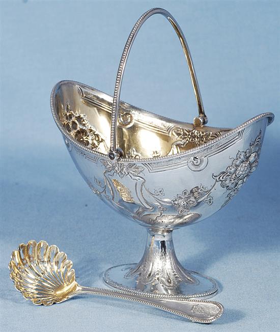 A Victorian silver swing handled sugar basket and sifter spoon, by Martin, Hall & Co, basket height 190mm, weight 7.7oz/241grms.